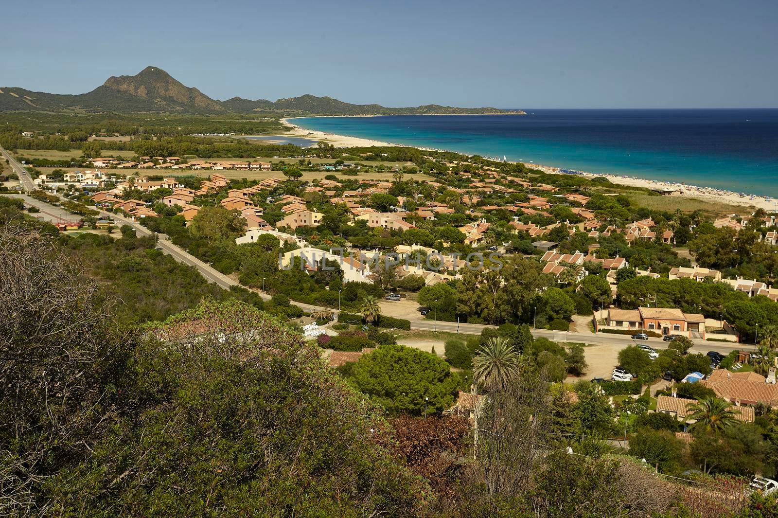 Aerial view of the village of Costa Rei in the south of Sardinia: a small tourist town built on the seashore, in a paradisiacal area.