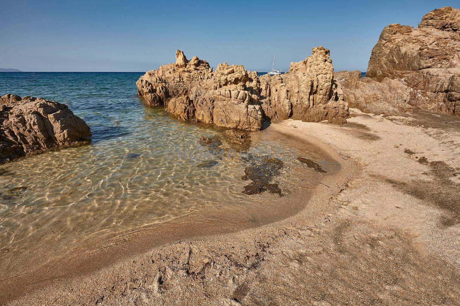 Rocks, crystal clear sea water and sun: the perfect symbol of a summer holiday in a true paradise.