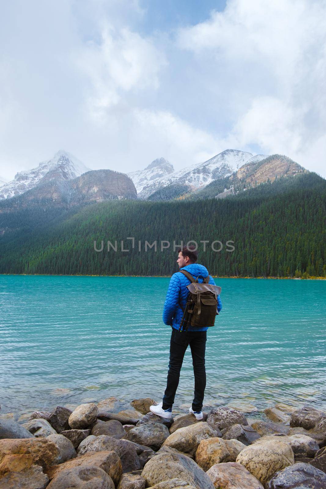 Lake Louise Banff national park is a lake in the Canadian Rocky Mountains. Young men visiting Lake Louise during a vacation in Canada