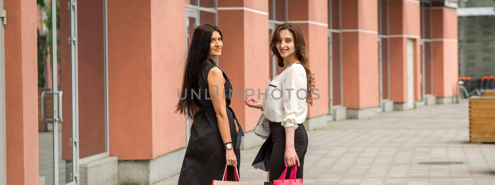 Two young women in shopping mall by okskukuruza