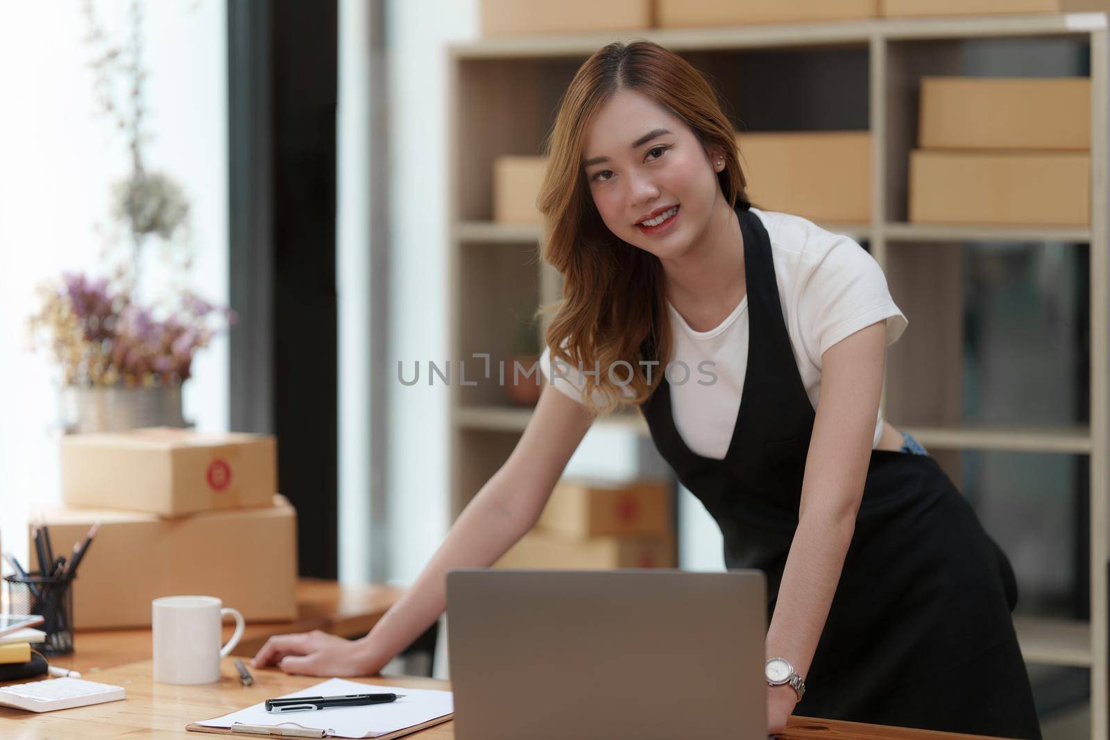 Asian SME business woman working at home office. online shopping concept.