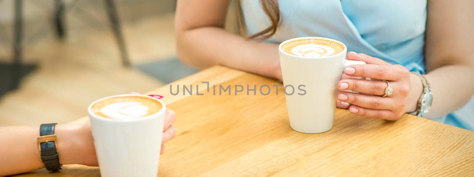 Female hands with cups of coffee by okskukuruza