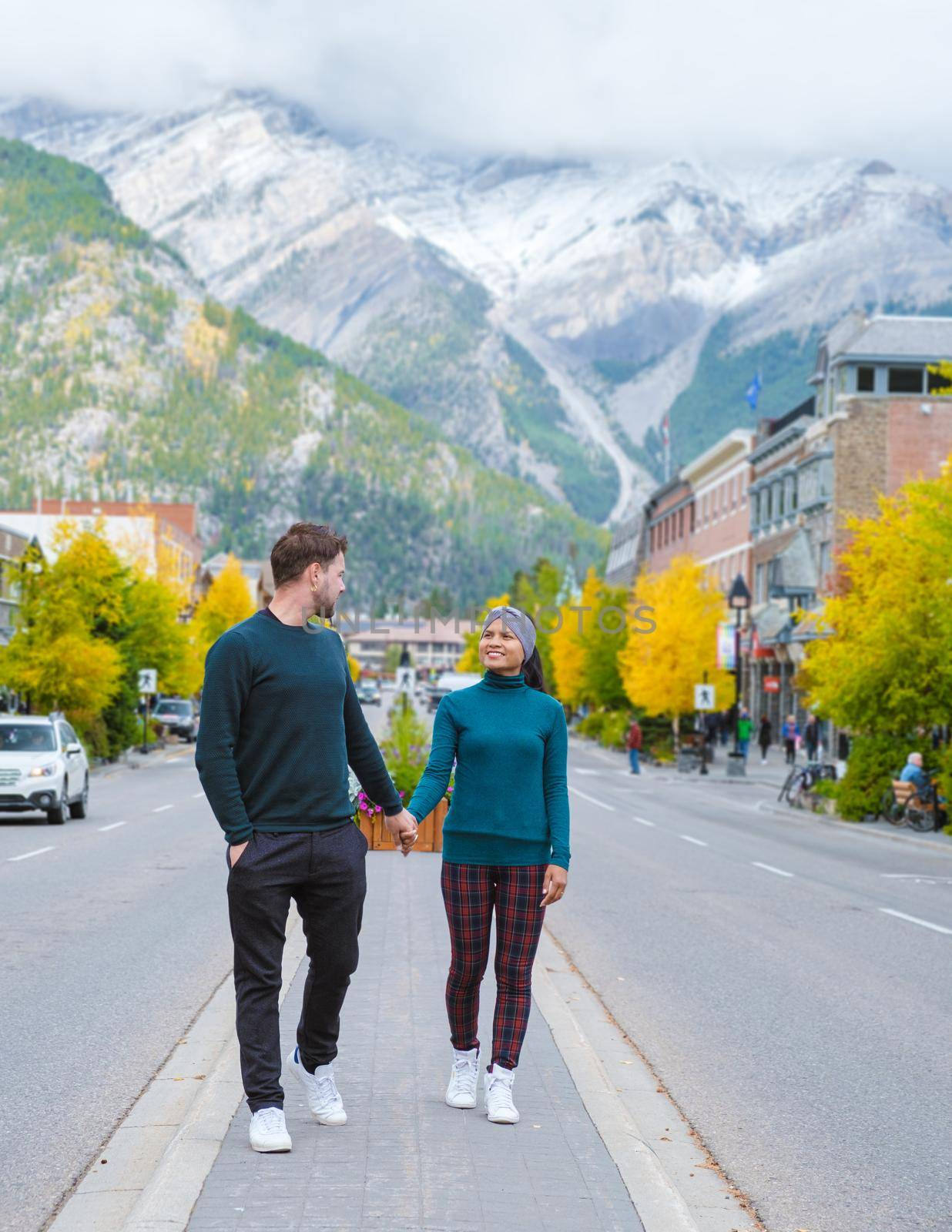 Banff village in Banff national park Canada Canadian Rockies during Autumn fall season. Couple of men and women on vacation in Banff Canada between the mountains