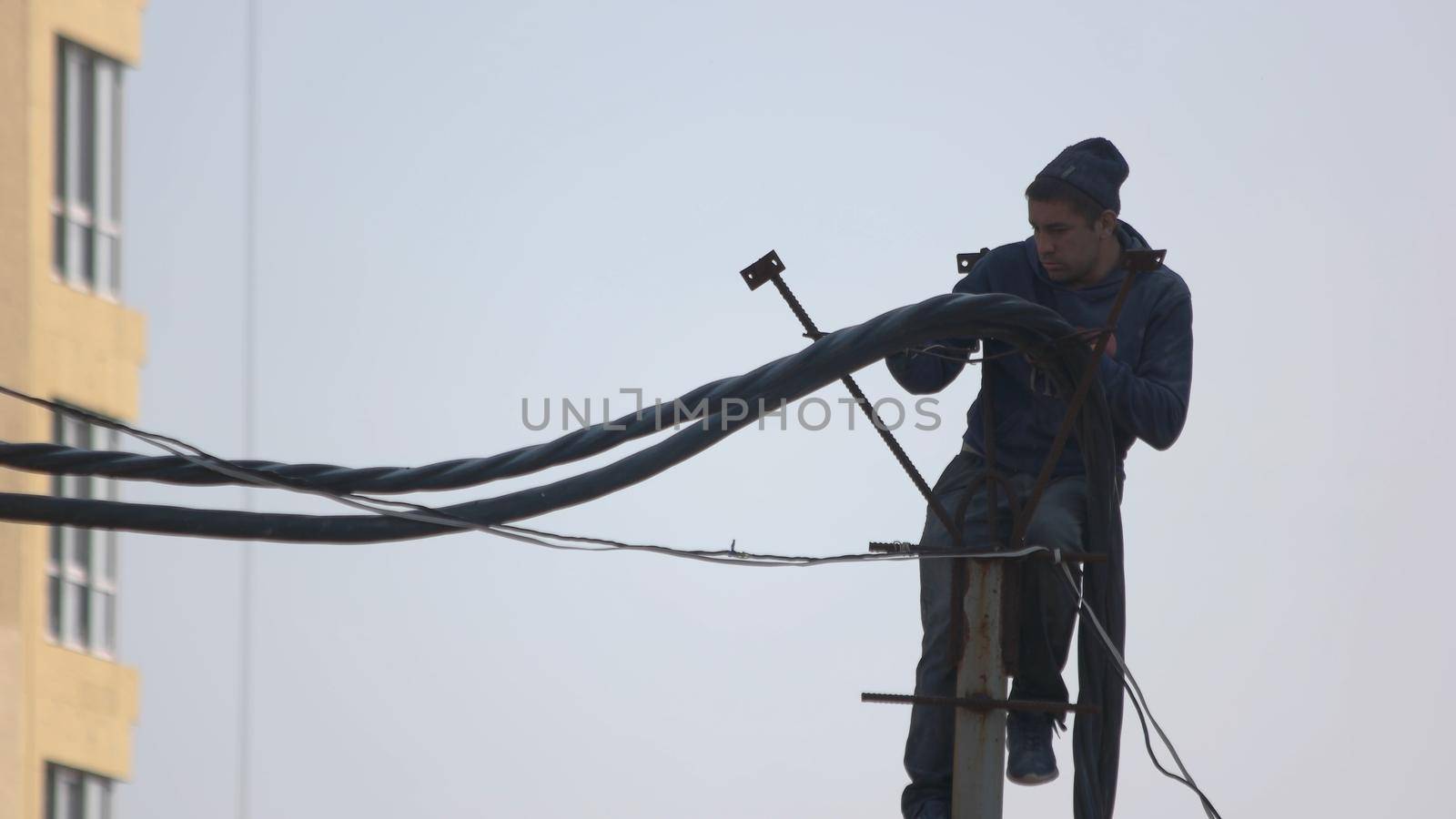 Construction worker installing wires in a new building. by super_picture
