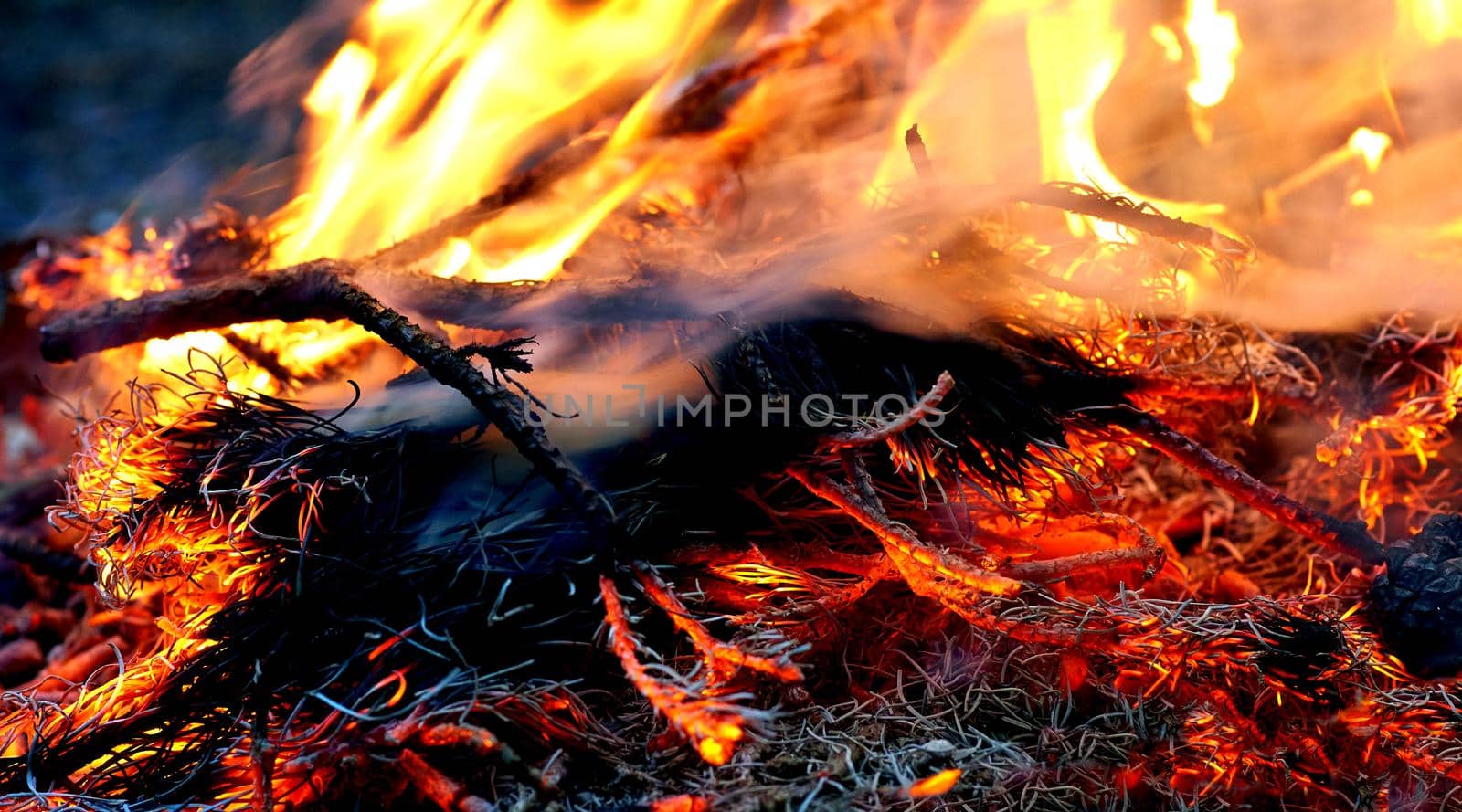 a large open-air fire used as part of a celebration, for burning trash, or as a signal.