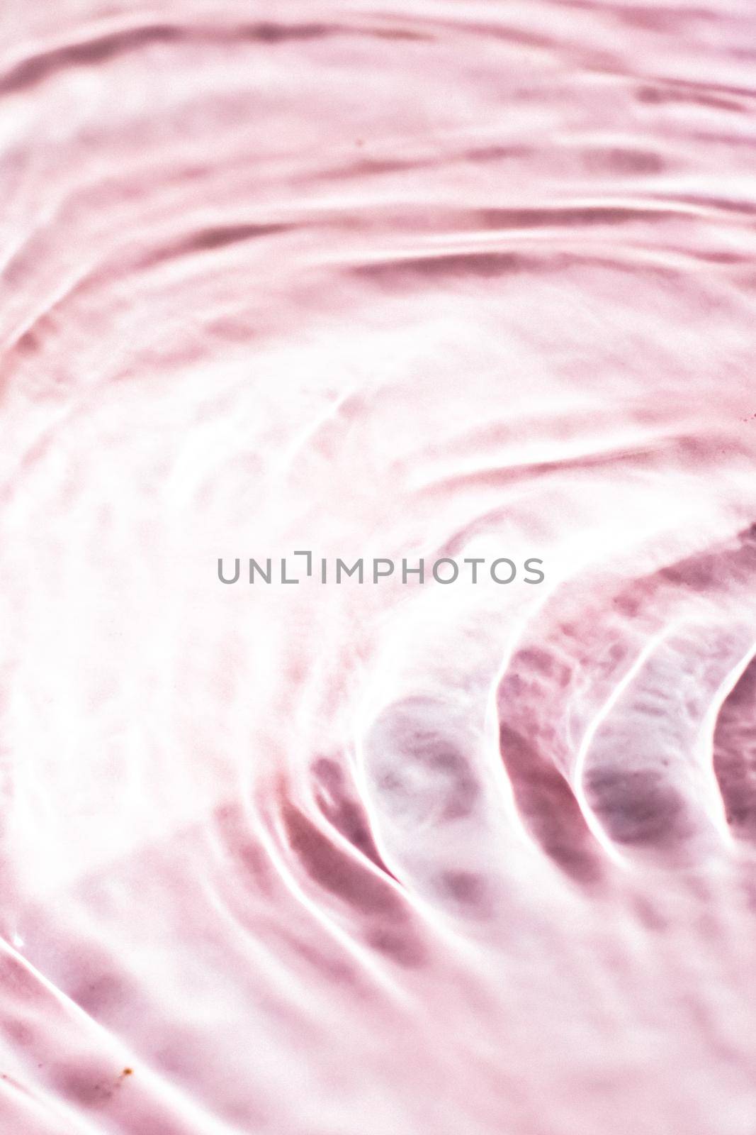 Pink flowing water texture as an abstract background - colourful liquids and creative designs concept. Pink flow