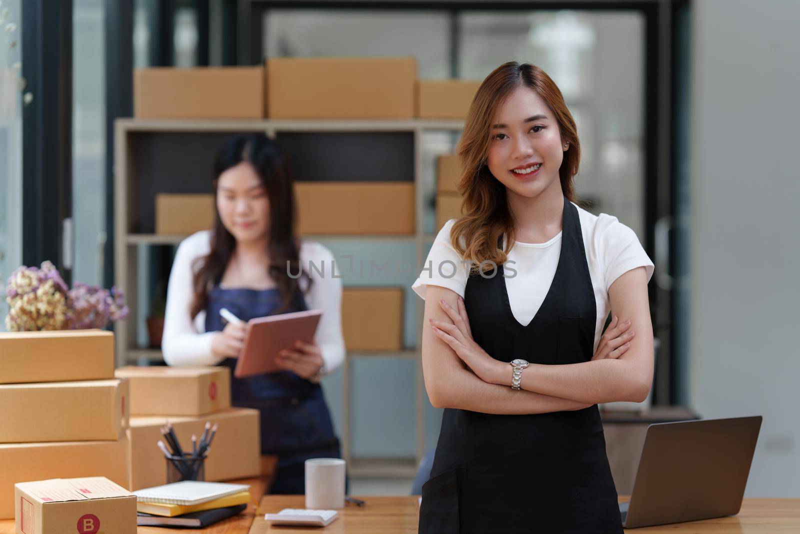 Asian SME business woman with partner working at home office. online shopping concept.