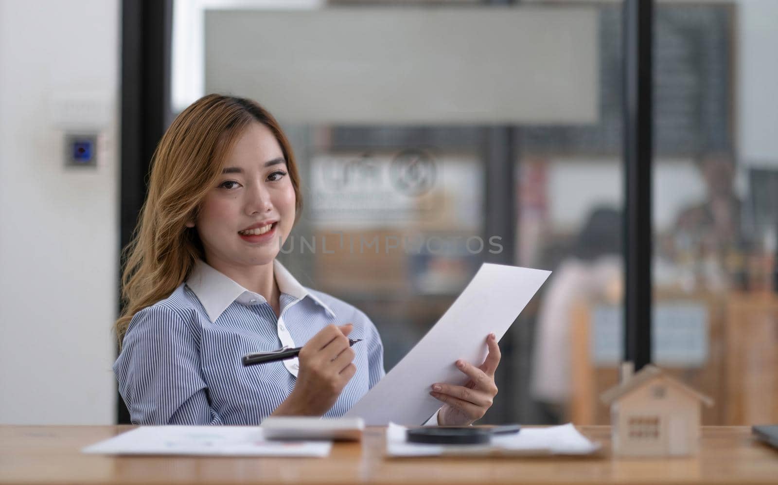 Portrait of smiling beautiful business asian woman with working in modern office desk using laptop computer, Business people employee freelance online marketing e-commerce telemarketing concept. by wichayada