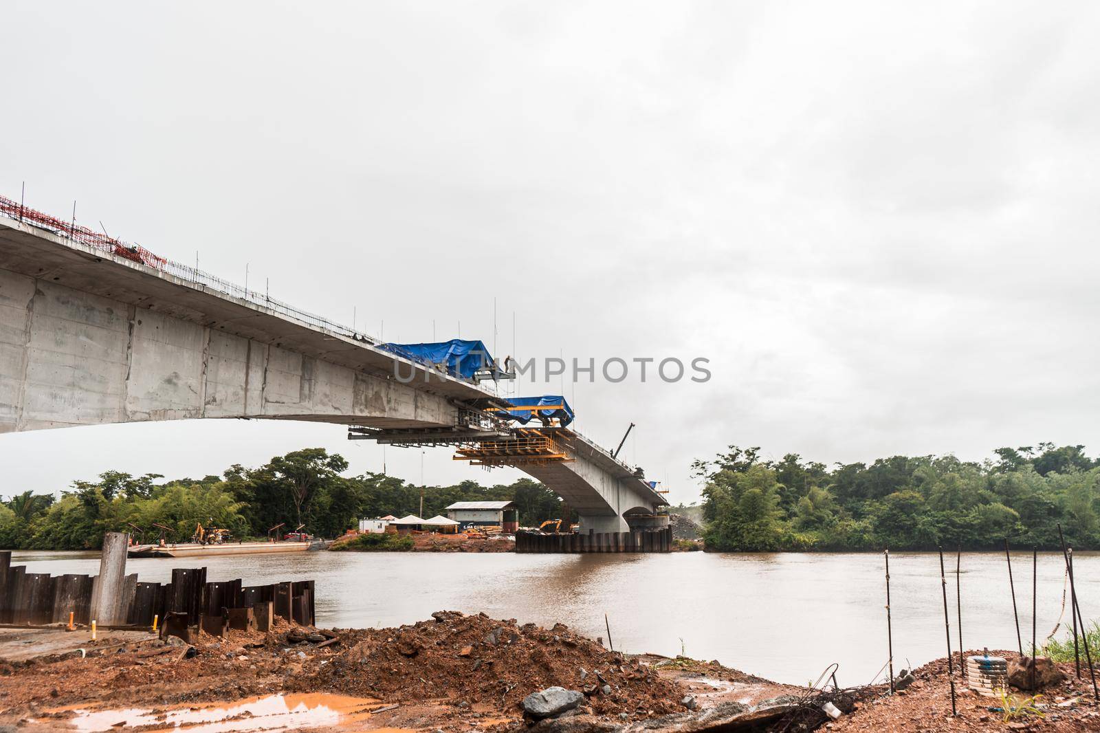 Bridge under construction crossing a muddy river in a Caribbean area of Nicaragua, Central America