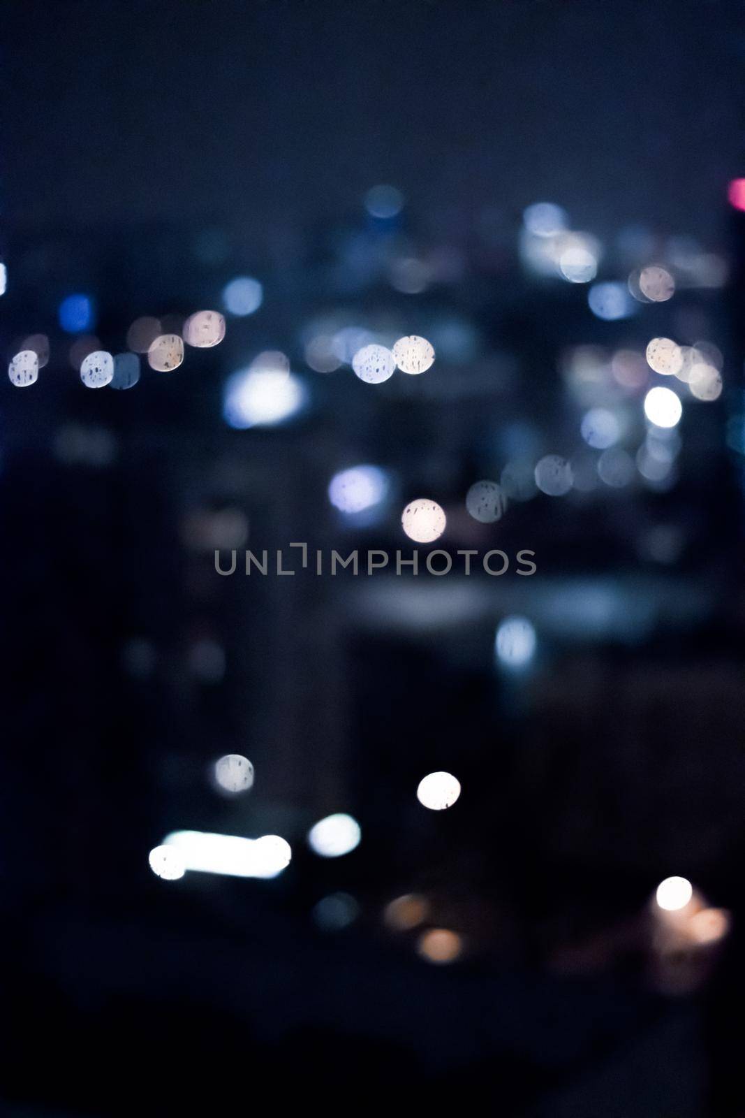 Blurry metropolitan district - night life, abstract background and modern dark tones concept. Big city comes alive at night