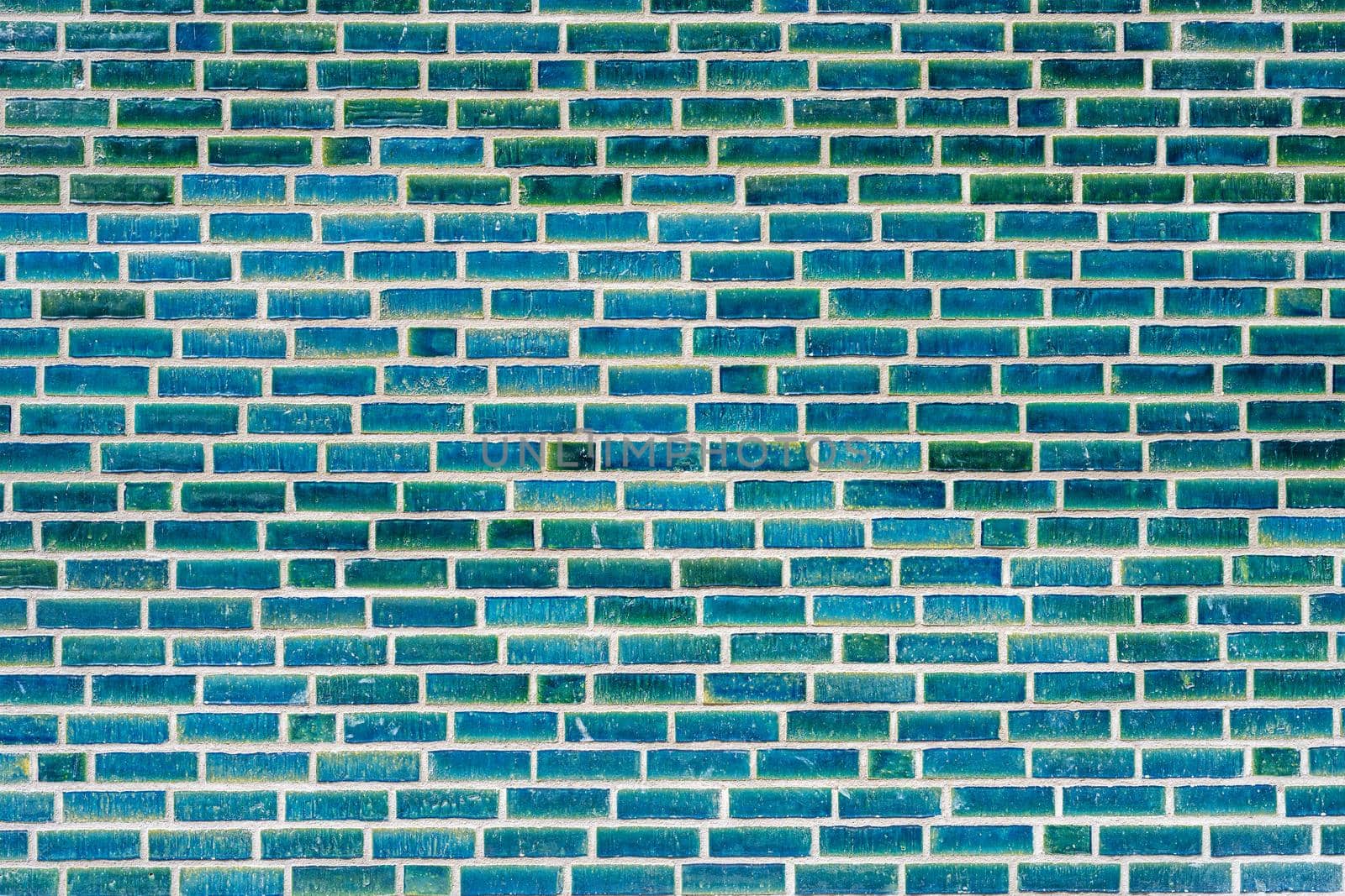 Background from a wall made of turquoise clinker bricks