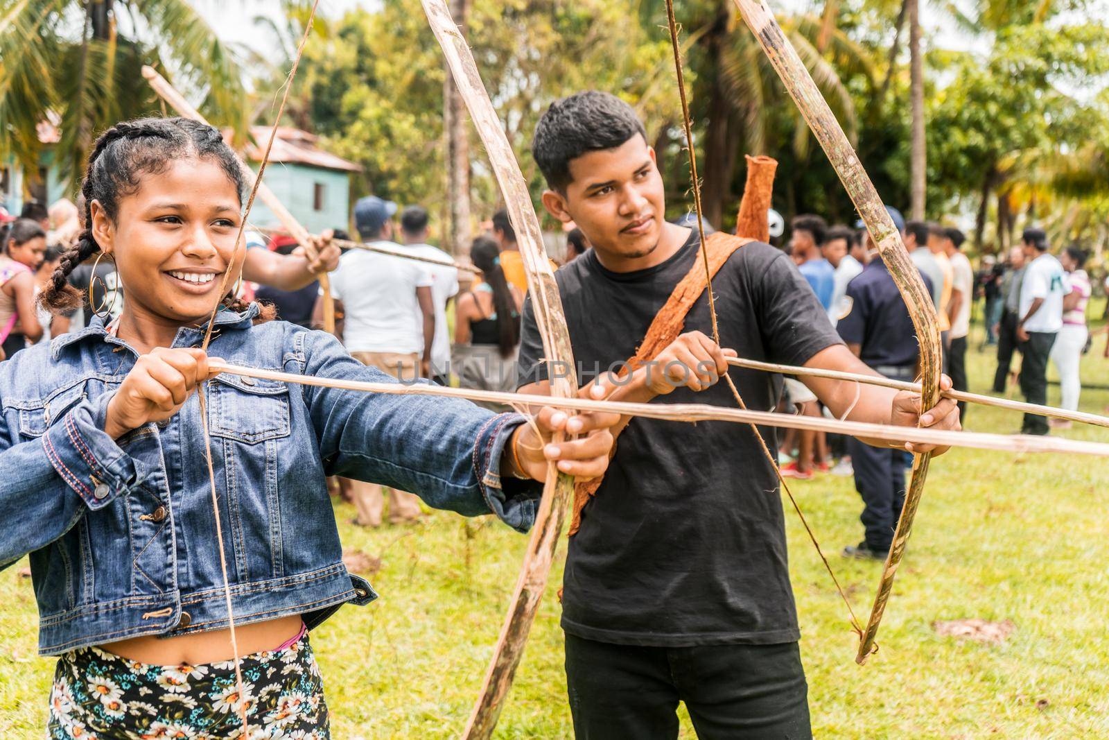 Young Afro-descendant man and woman posing with bow and arrow on the Caribbean coast of Nicaragua