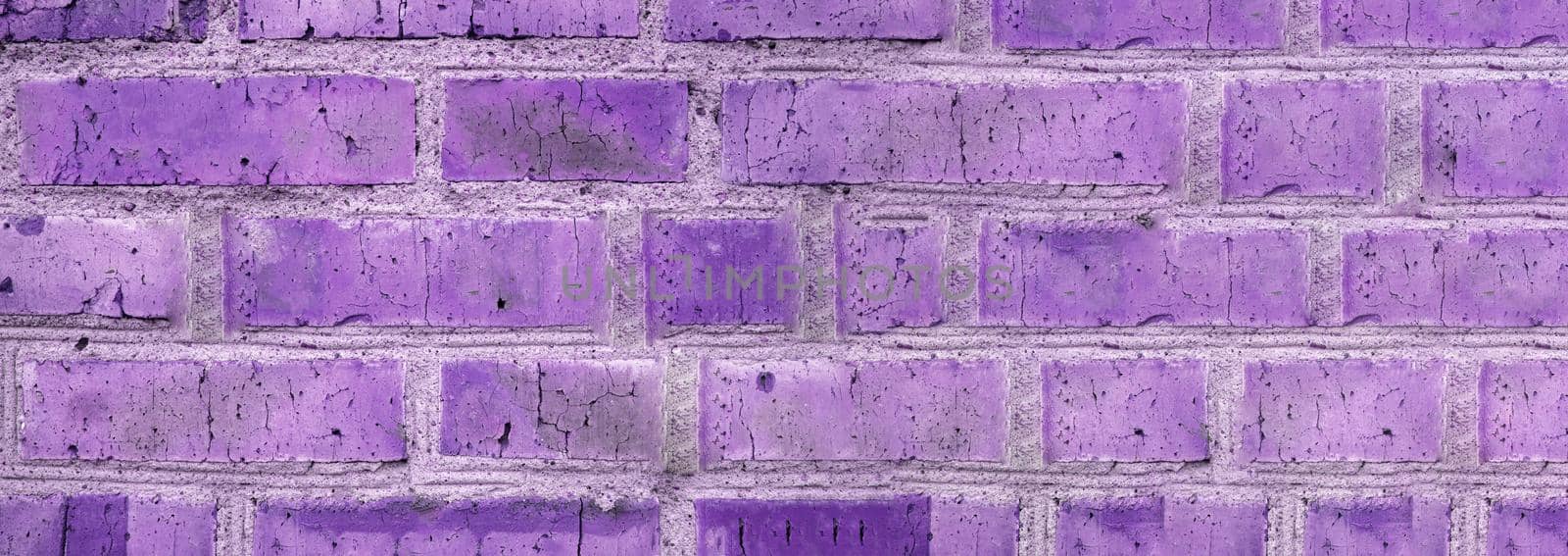Banner background of an old brick wall, vintage brickwork texture, close-up, purple tinting.
