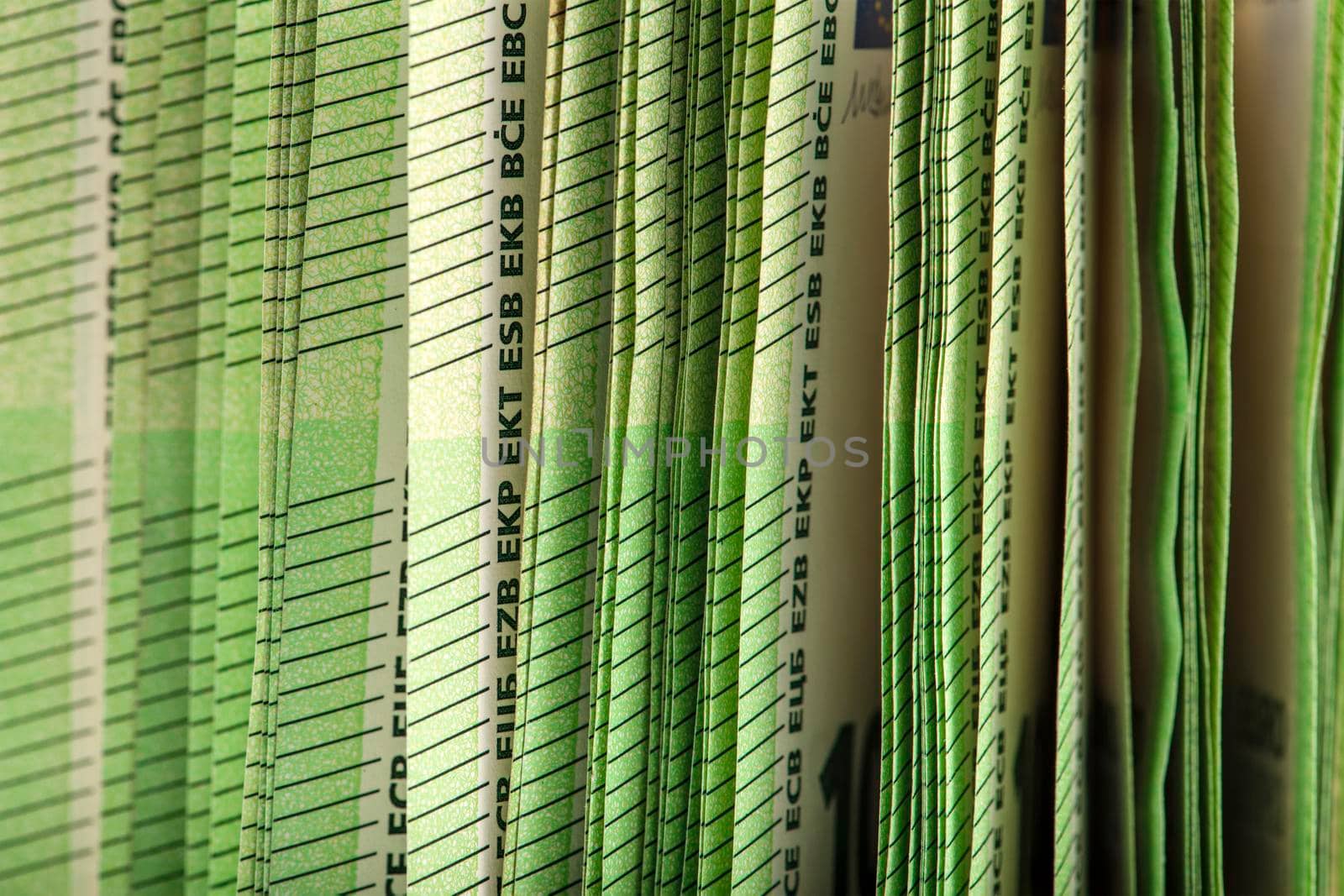 Close-up of a stack of paper bills, side view. Euro banknotes stacked on top of each other. Big pile of money
