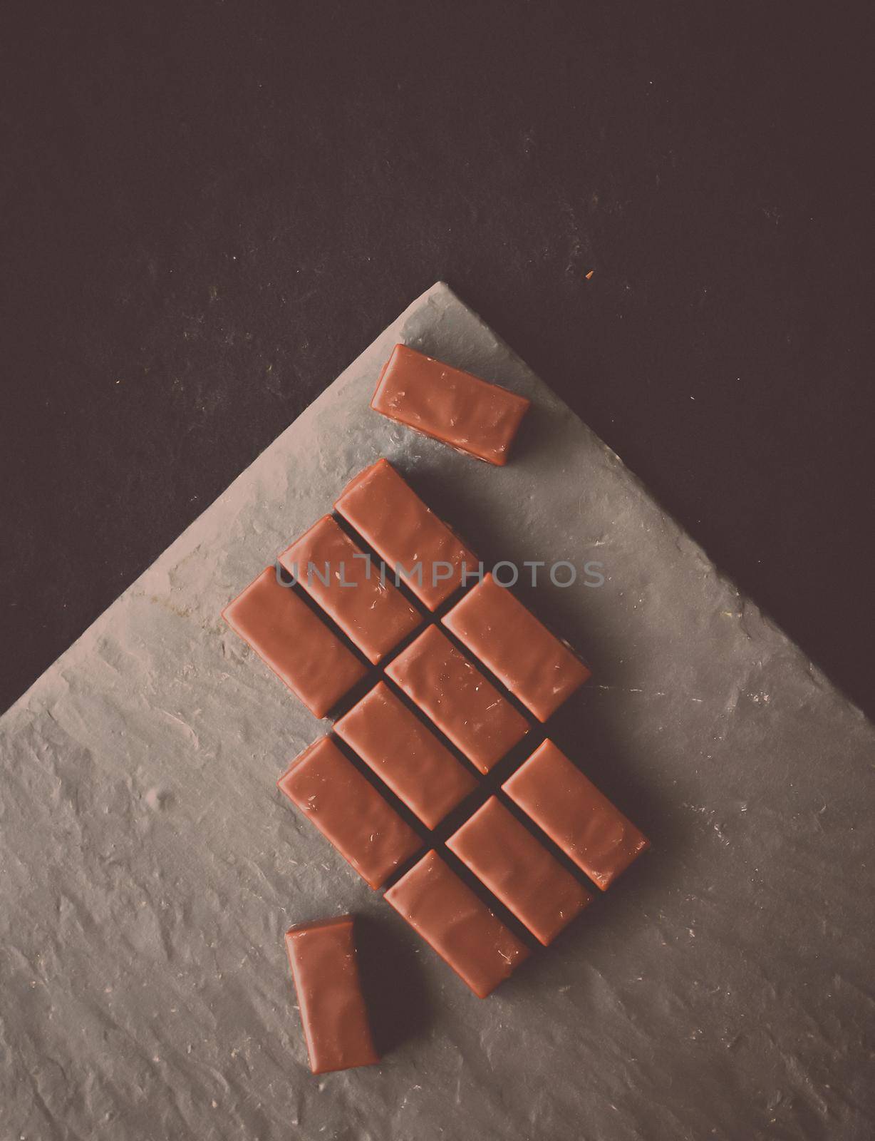 Sweet swiss chocolate candies on a stone tabletop, flatlay - desserts, confectionery and gluten-free organic food concept. All you need is chocolate