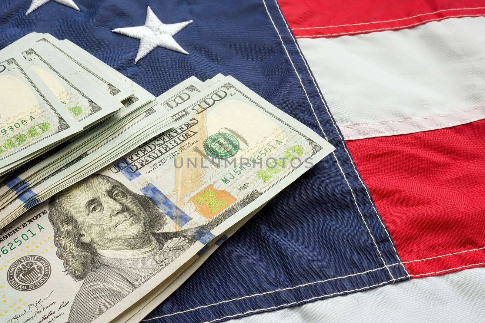 Cash on USA flag as symbol of taxes, inflation, the state budget.