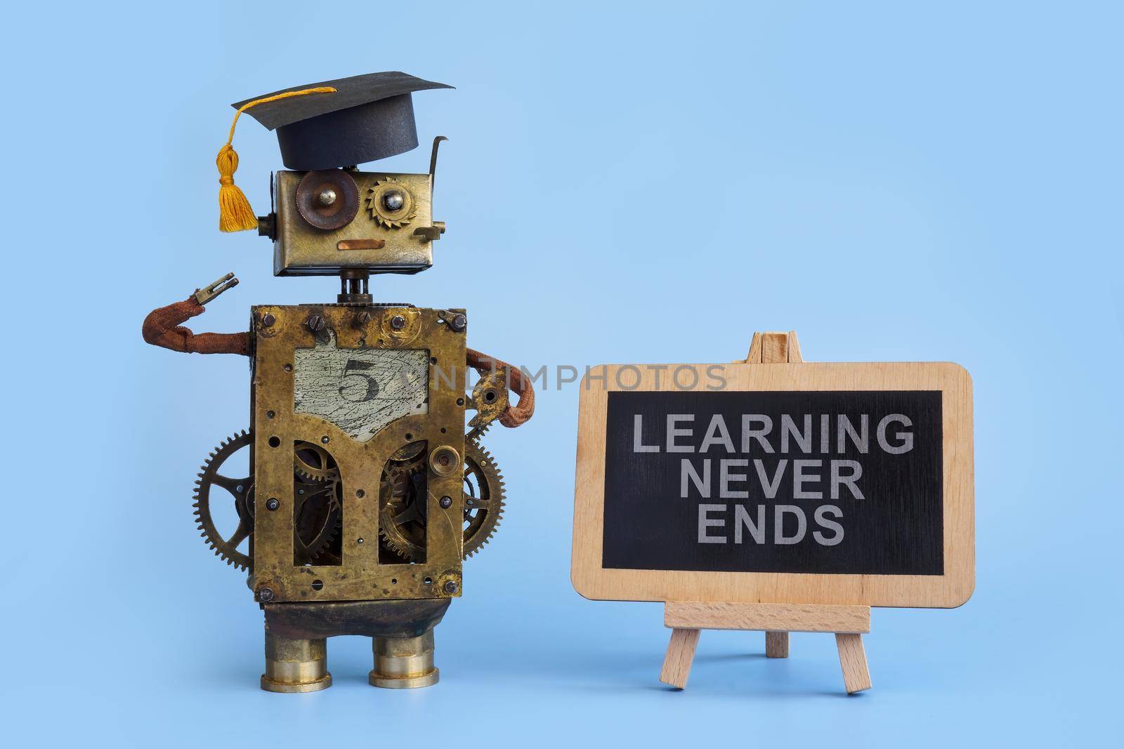 A Blackboard with sign Learning never ends and old robot.