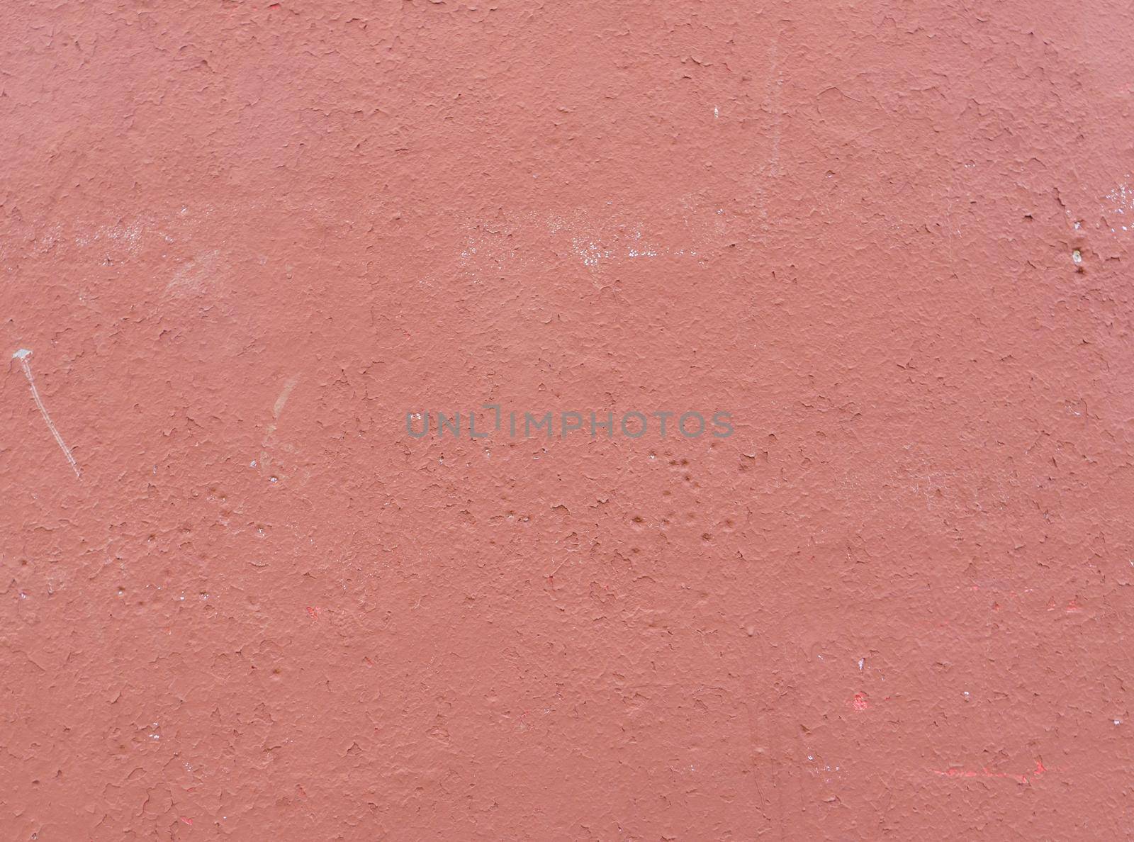 Old peeling red paint on an old wall. Abstract background for design. red cement wall texture