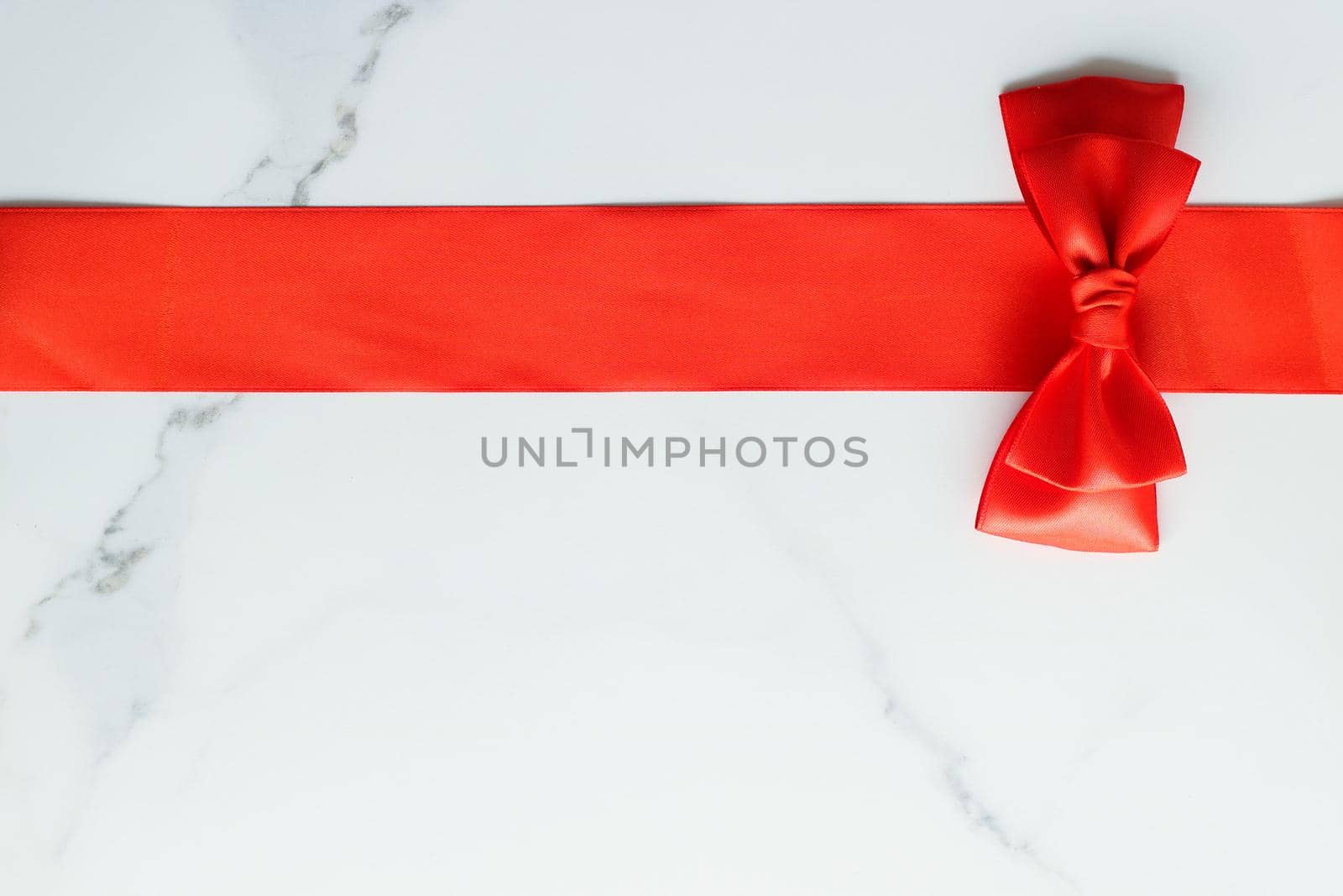 Holiday decor, feminine design and flatlay concept - Red silk ribbon on marble, top view