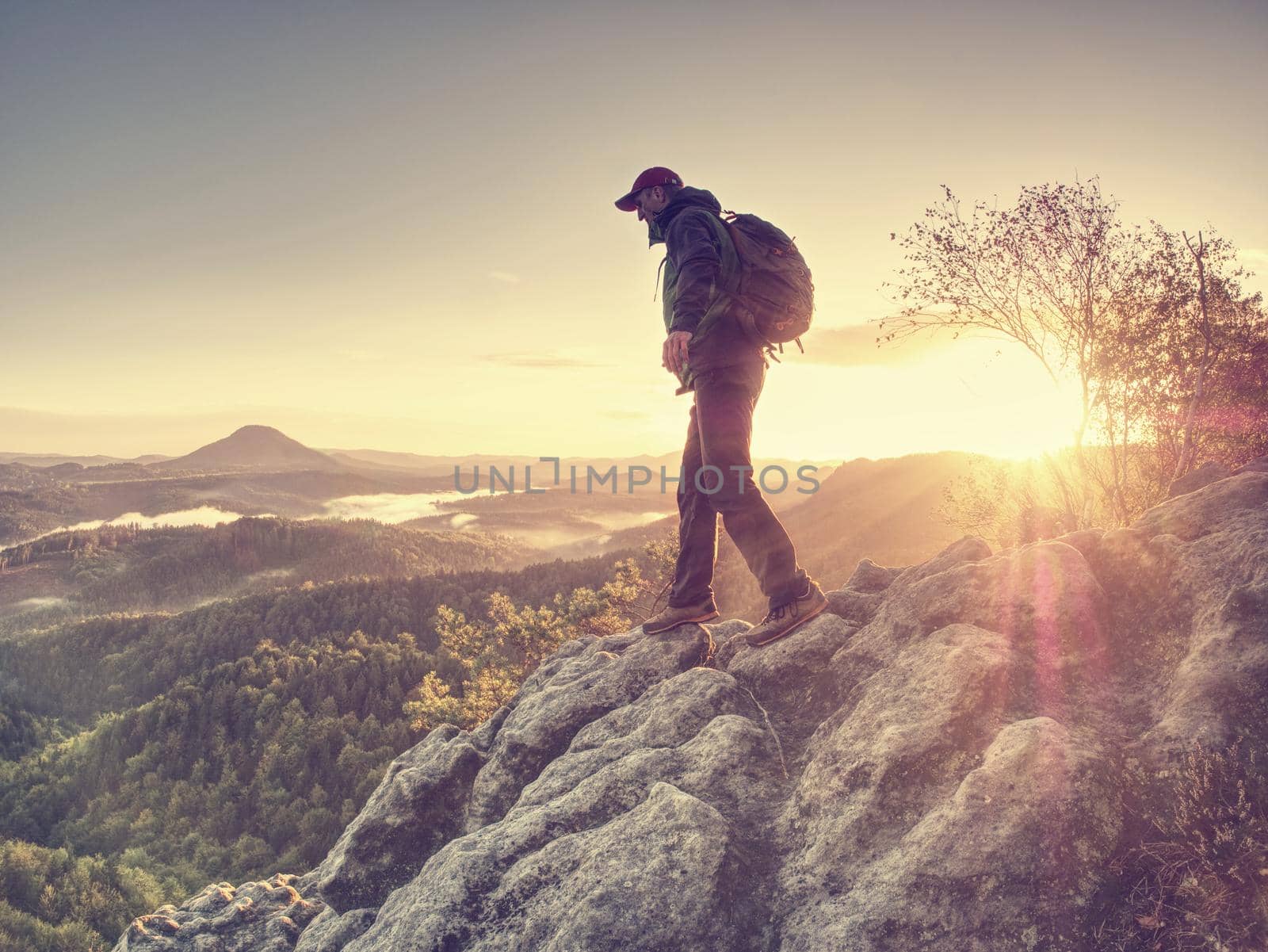 Moment of loneliness. Man on the rock empires watch  by rdonar2