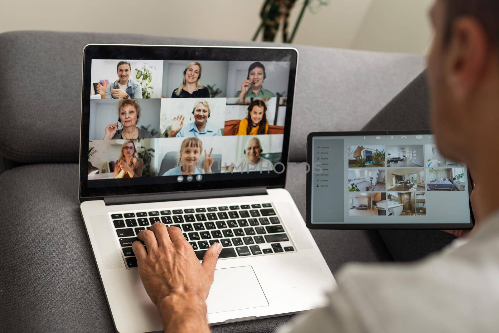 man working from home use Smart working and video conference online meeting with team using laptop and tablet online in video call for new projects.