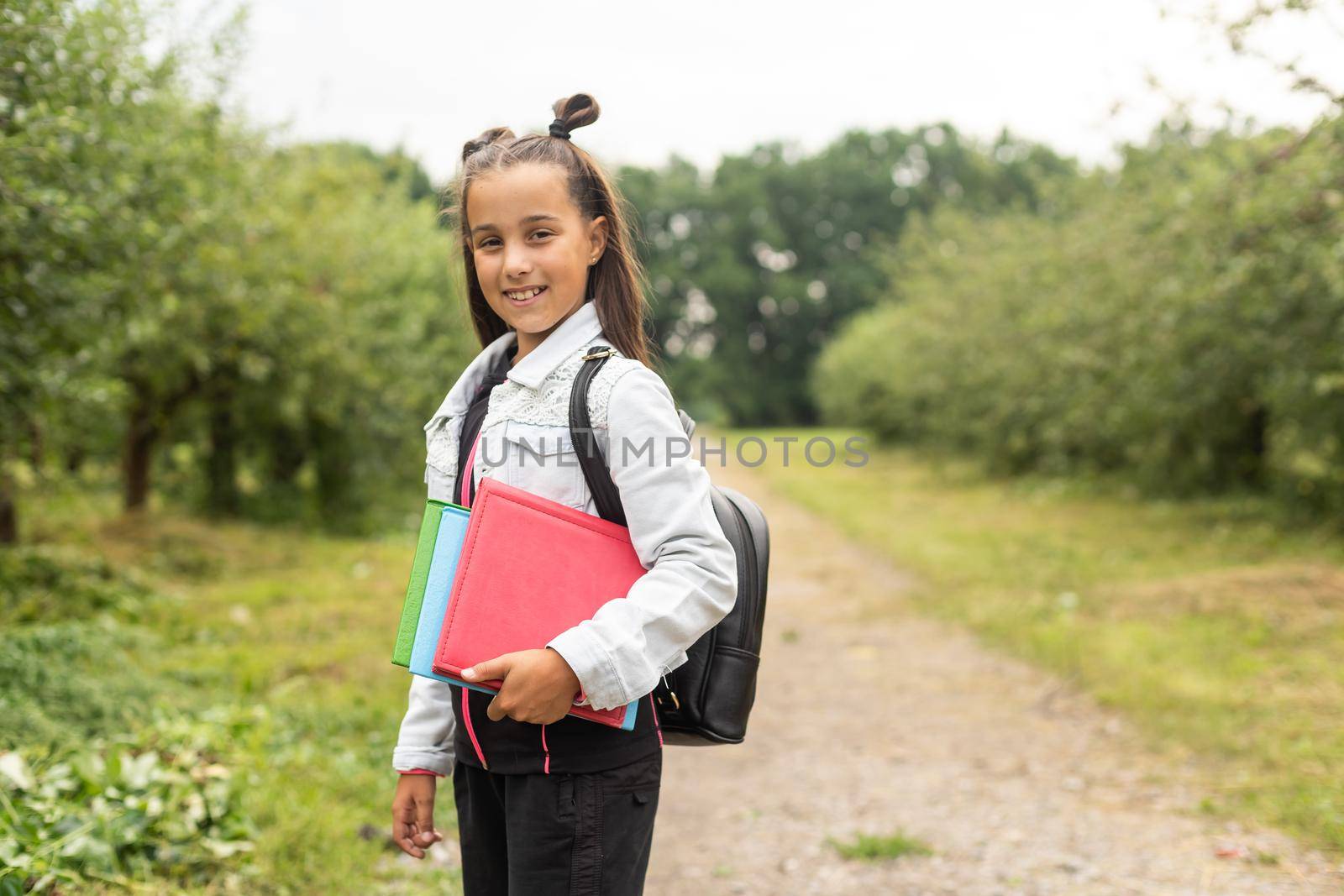 Back to school - lovely schoolgirl on the way to the school. by Andelov13