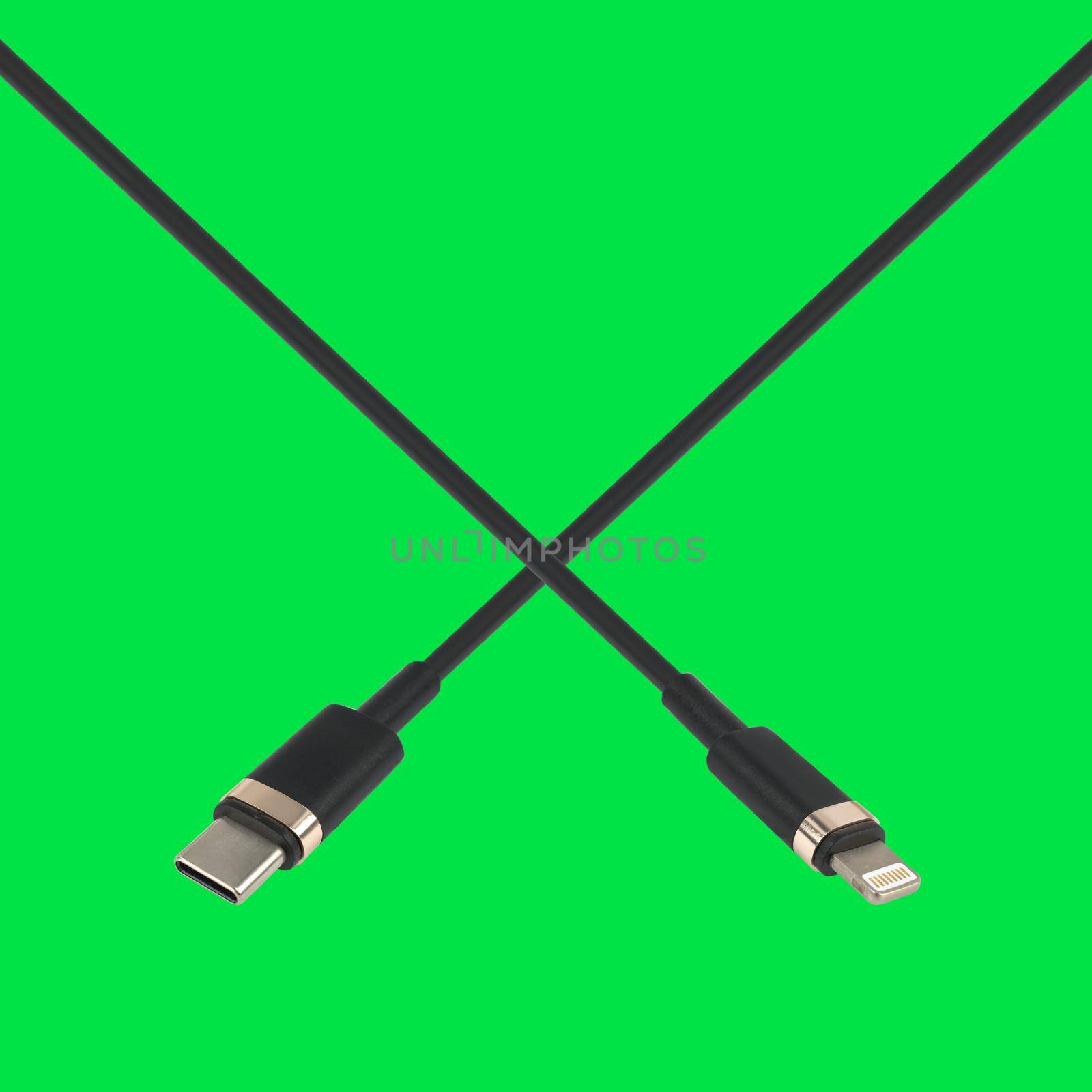 cable with Type-C connector and Lightning, on a green background in isolation