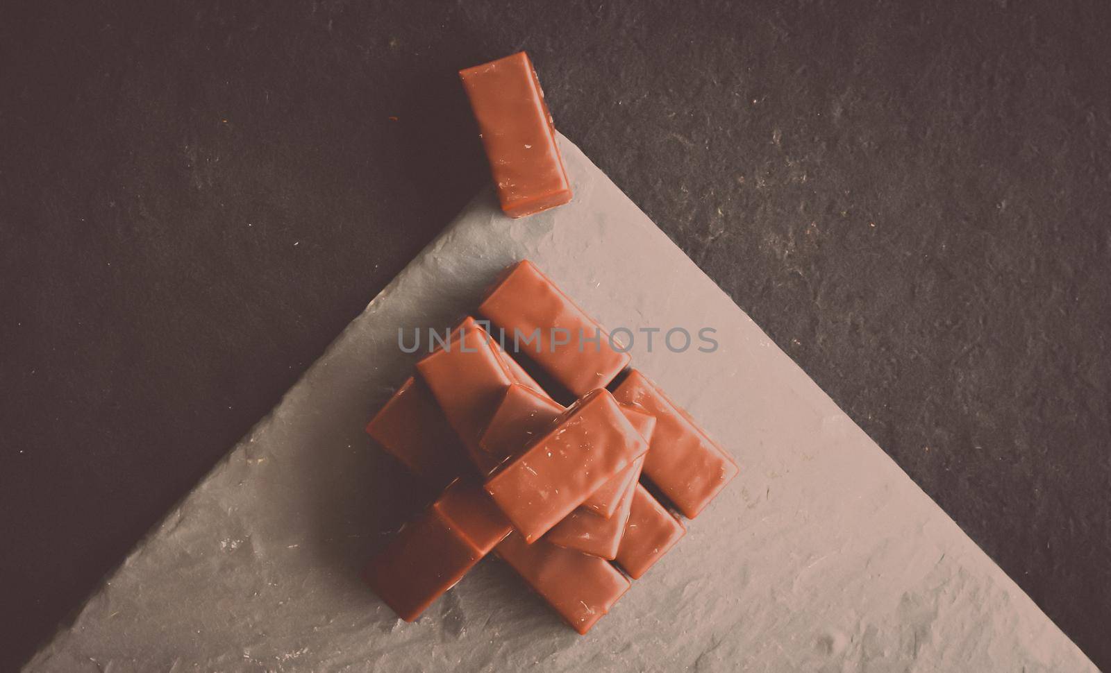 Sweet swiss chocolate candies on a stone tabletop, flatlay - desserts, confectionery and gluten-free organic food concept. All you need is chocolate