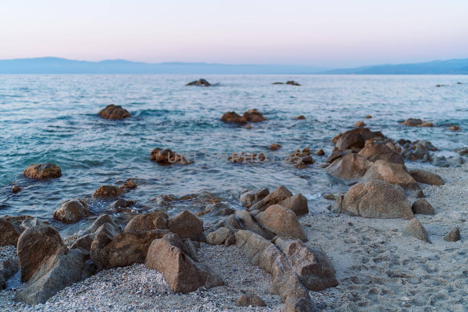 Beautiful view of orange sunset seascape with rocks in Italy. Colorful sunrise landscape by photolime