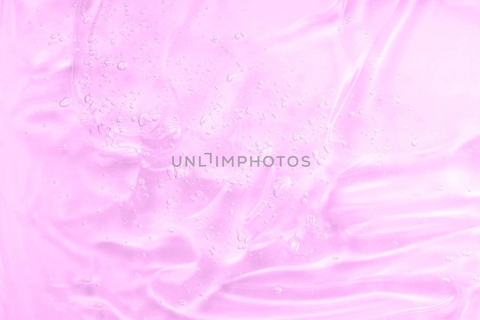 Pink gel texture. Cosmetic clear liquid smudge. Transparent skin care product by photolime