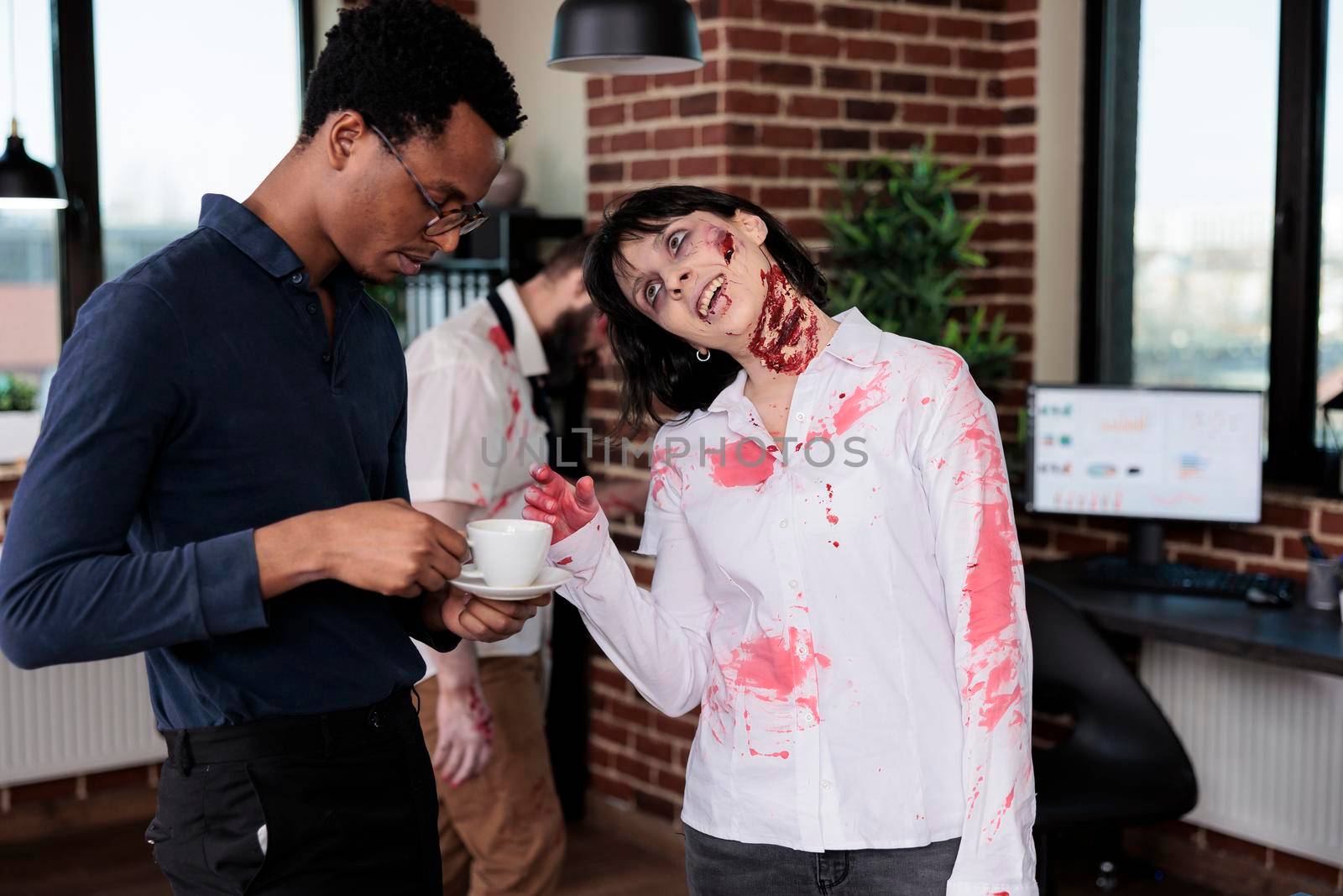 Spooky evil zombie talking to man at workplace, macabre cruel monster corpse in business office acting aggressive and dangerous. Scary undead devil with bloody wounds in company space.