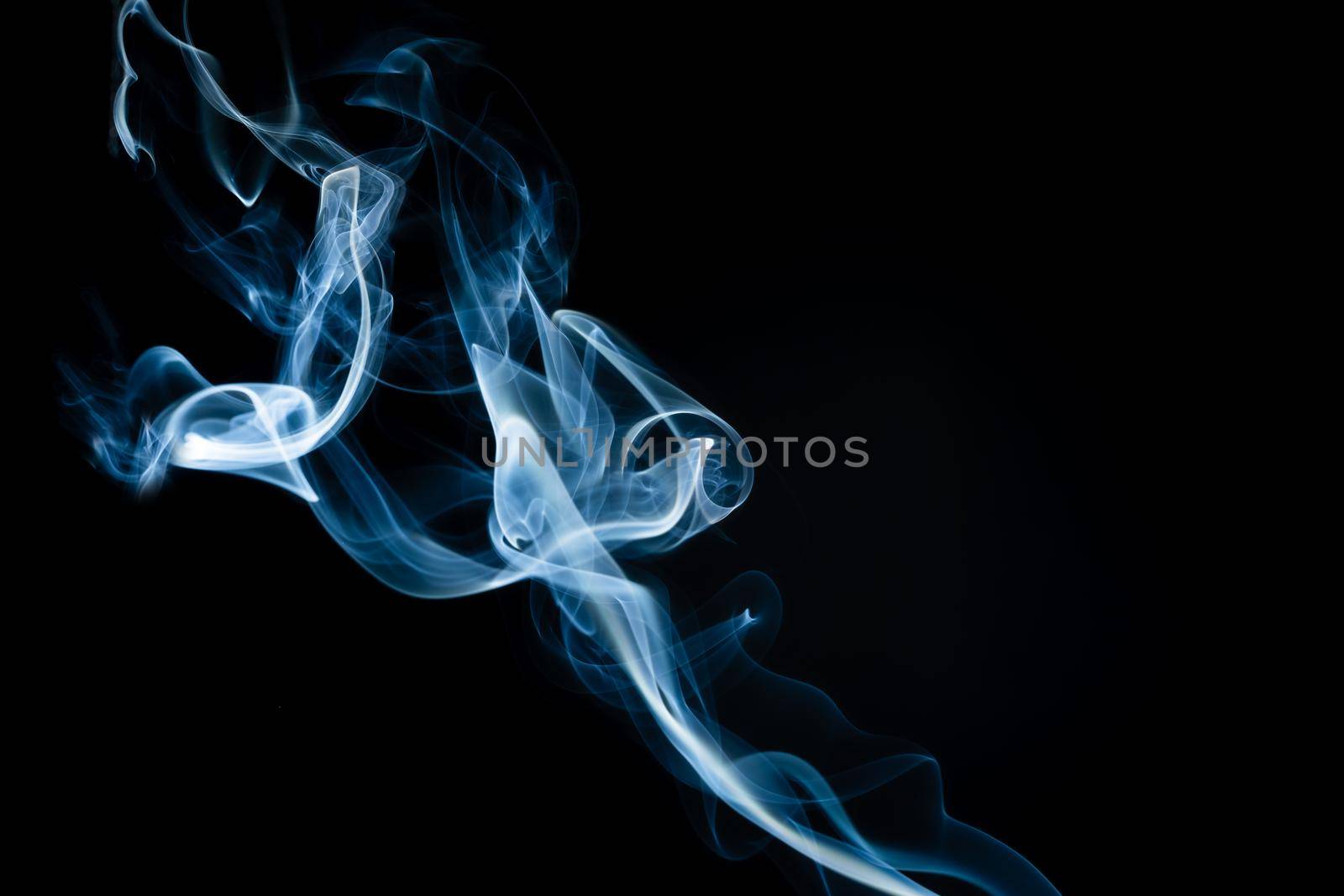 Abstract shape of colored Smoke on a black background. copy space.