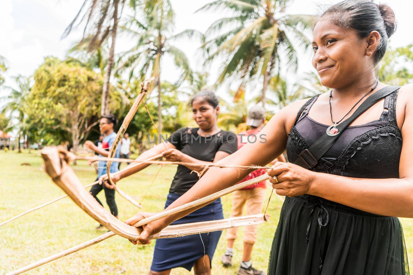 Indigenous women from Nicaragua, Central America shooting arrows with a bow in a Miskito community