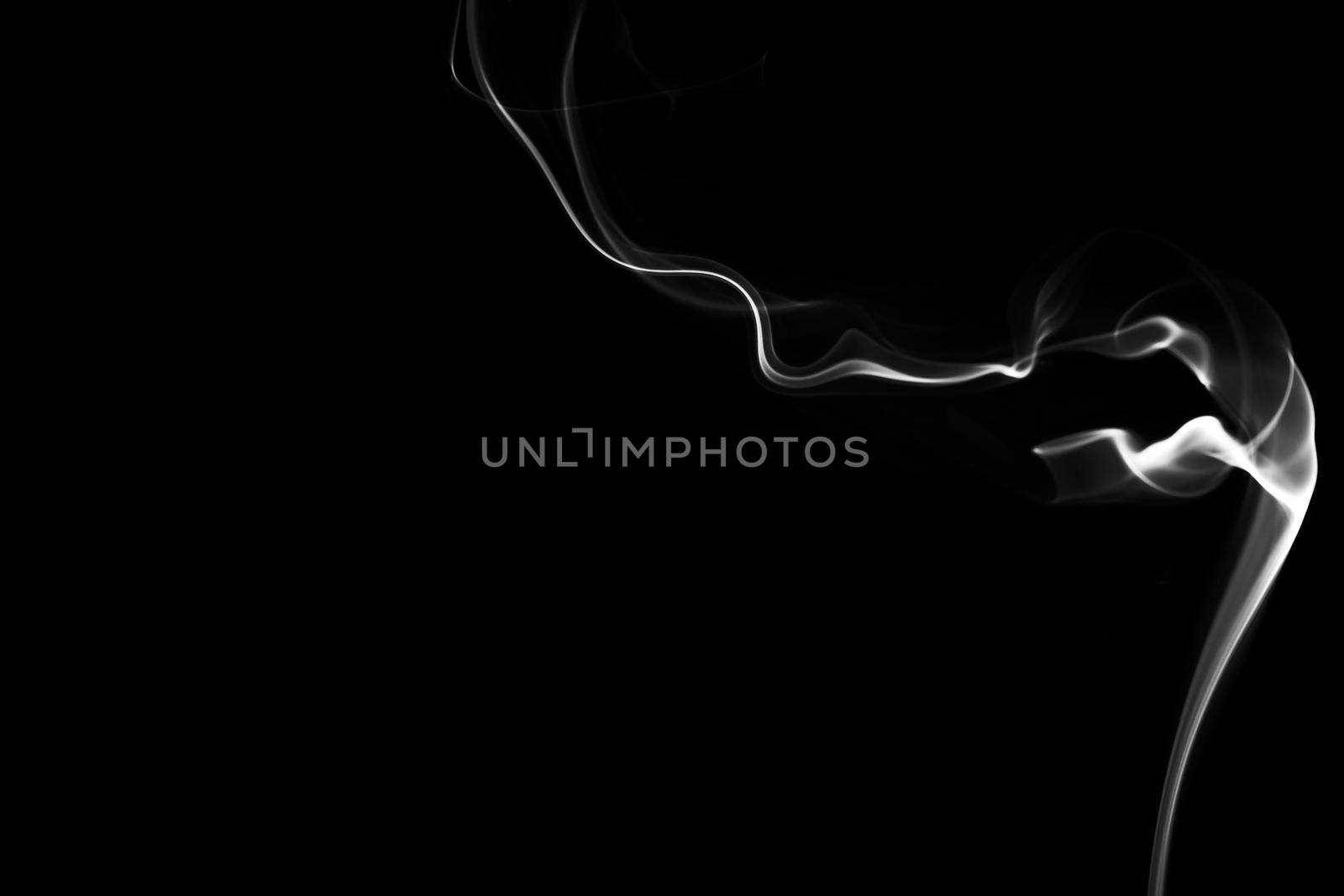 Abstract form of Smoke in black and white on a black background. Copy space