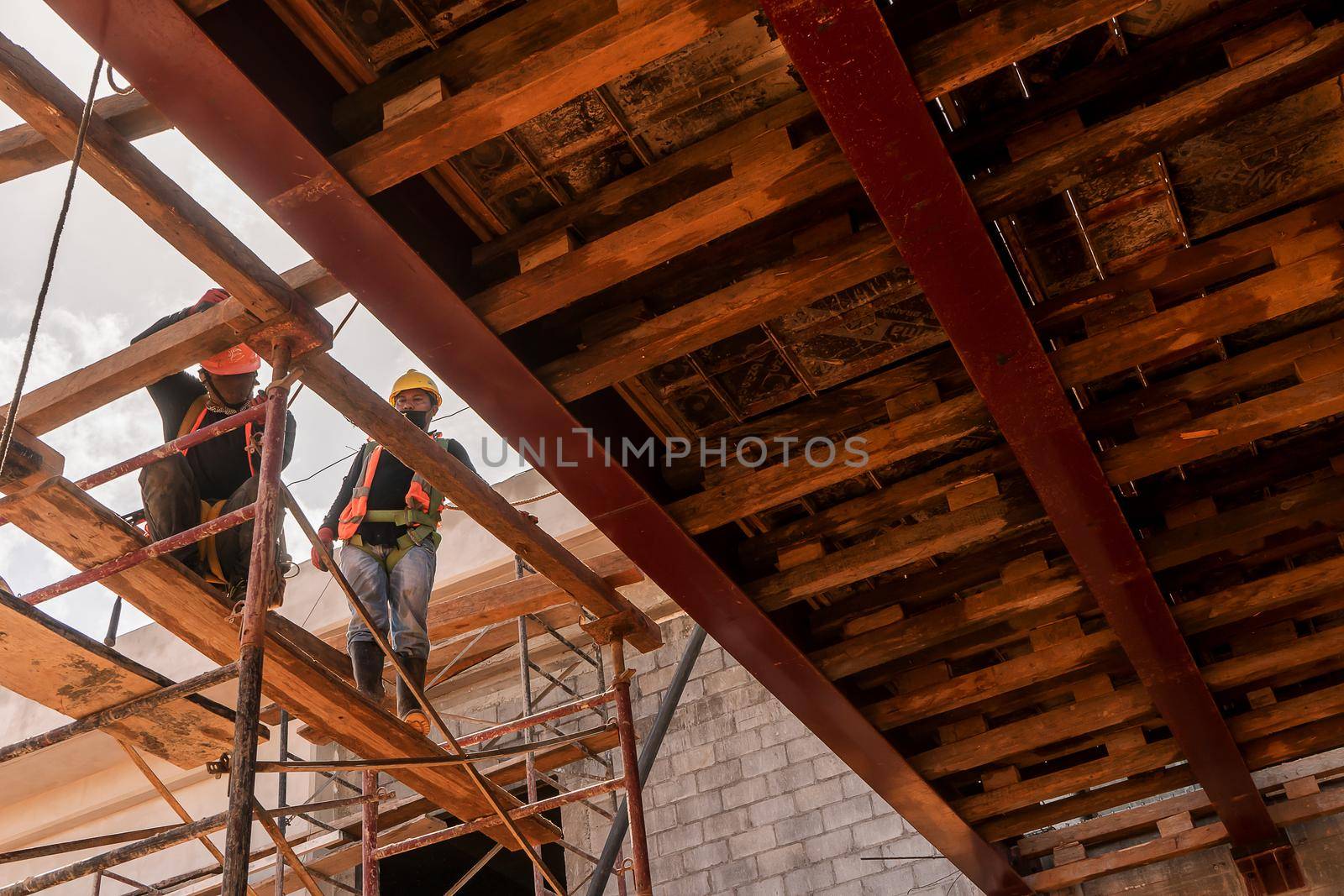 Two Latino blue collar workers supervising the construction of a building in Nicaragua, Central America
