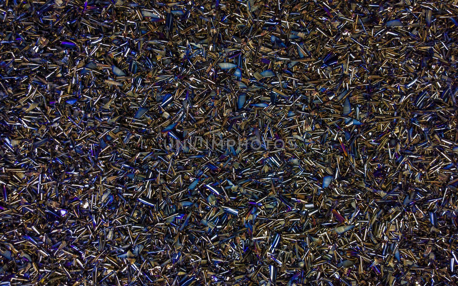 Colored black Steel Chips flat background with natural thermal surface hardening discoloration.
