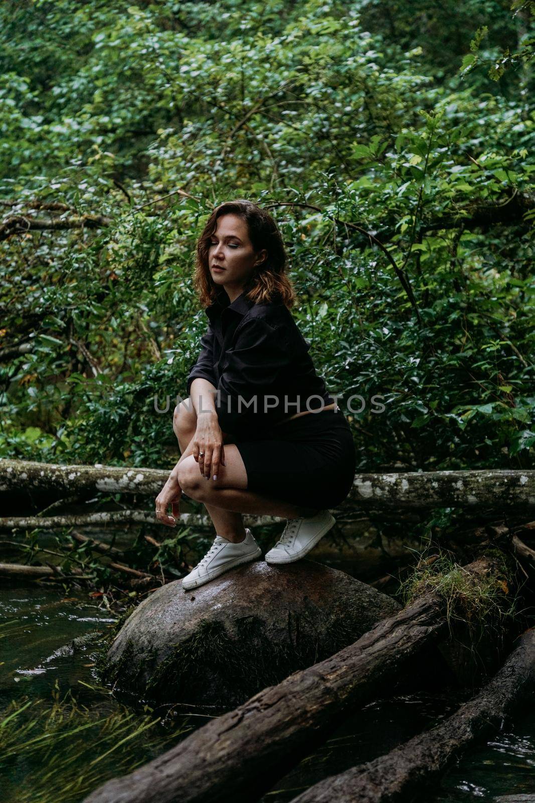 Woman in black clothes. Walk in a dark coniferous forest. Tracking and trip by natali_brill