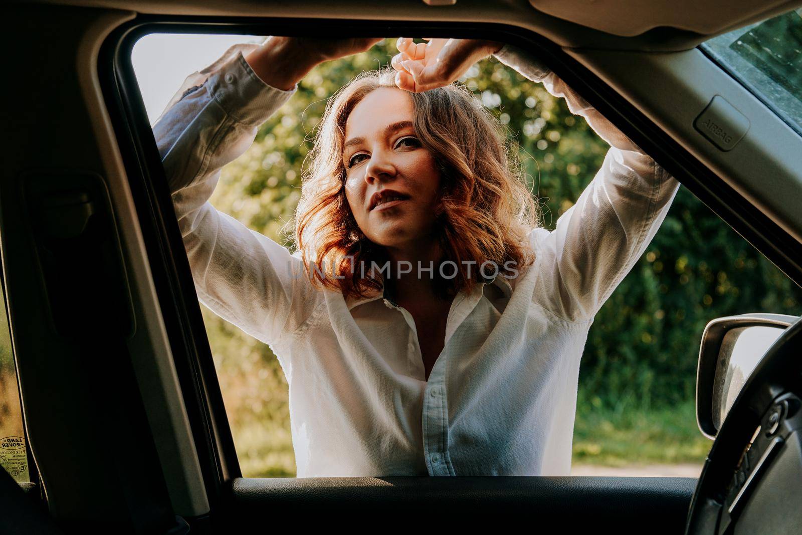 Woman in the car window. Trips and travels out of town. Travel and joy concept by natali_brill