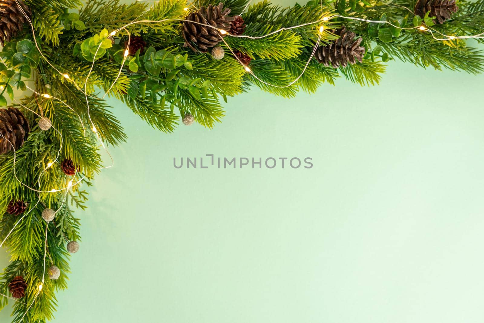 Christmas tree corner decoration on green background, flat lay by Mariakray