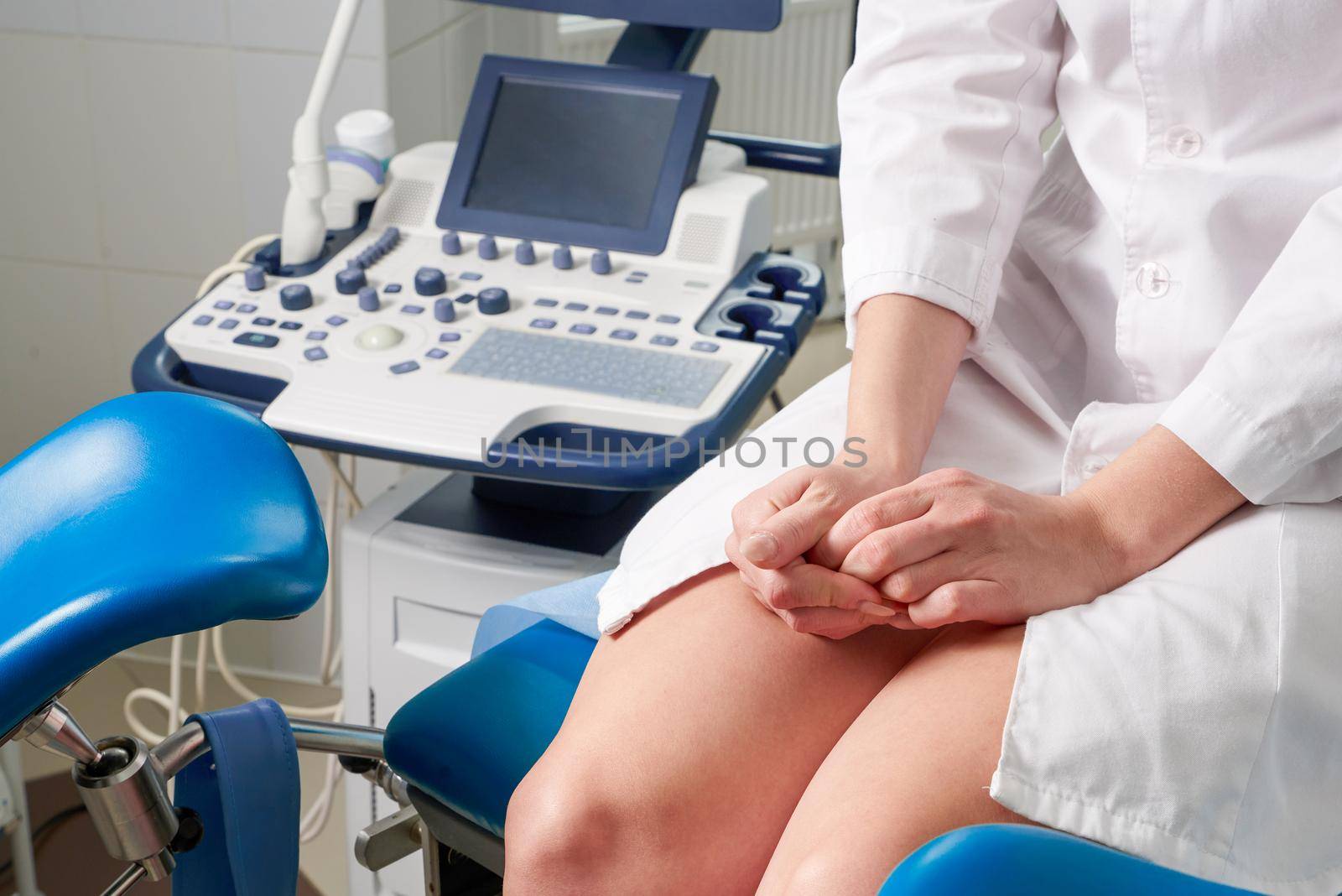 Woman at gynecologist office sitting and waiting for a doctor with test results by Mariakray