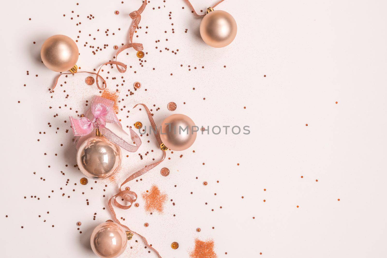 Christmas balls, pink and golden decorations on white background. top view, copy space by Mariakray