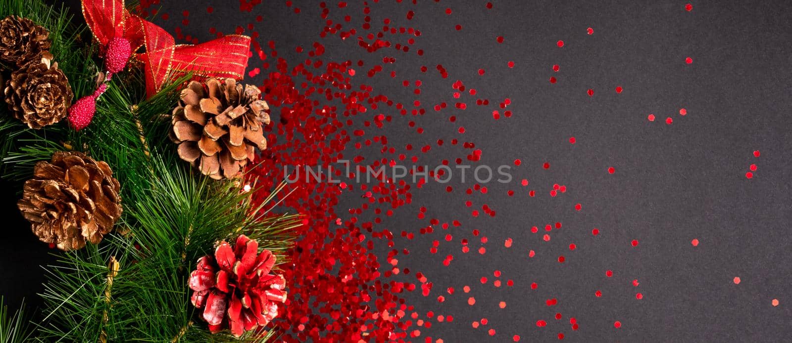Christmas wreath with red glitter on black background, flat lay with copy space by Mariakray