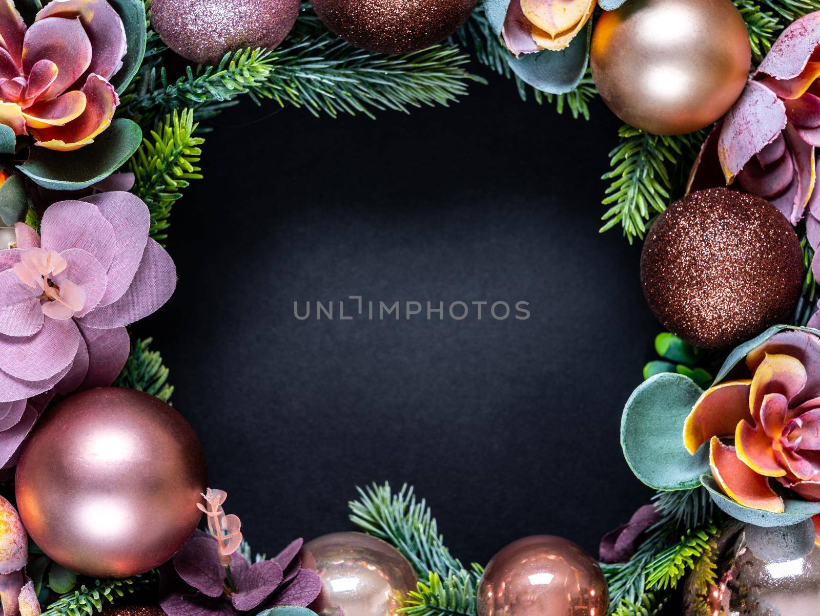 Frame made of Beautiful unusual Christmas wreath decoration on black background. flat lay by Mariakray