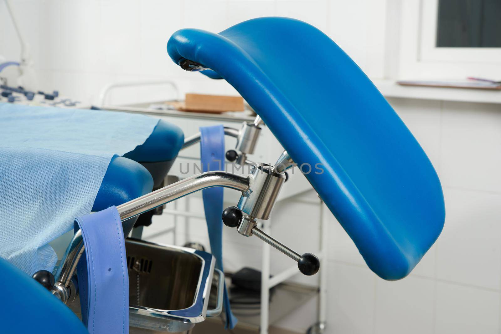 Gynecological room with chair and equipment in modern clinic by Mariakray