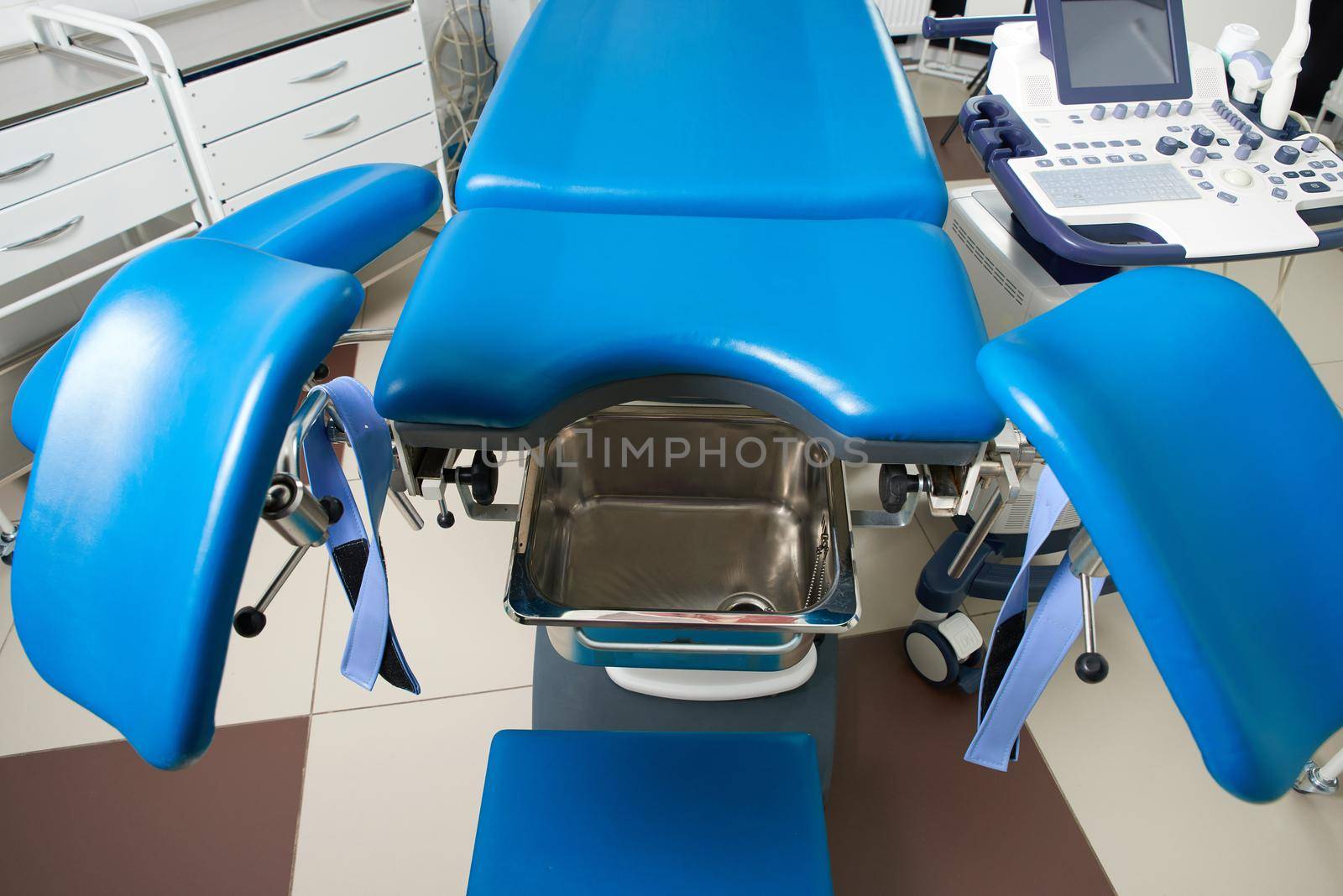 Gynecological room with chair and equipment in modern clinic by Mariakray