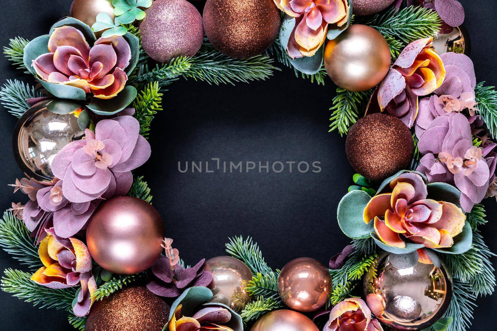 Beautiful unusual Christmas wreath decoration on black background. flat lay with copy space in center by Mariakray