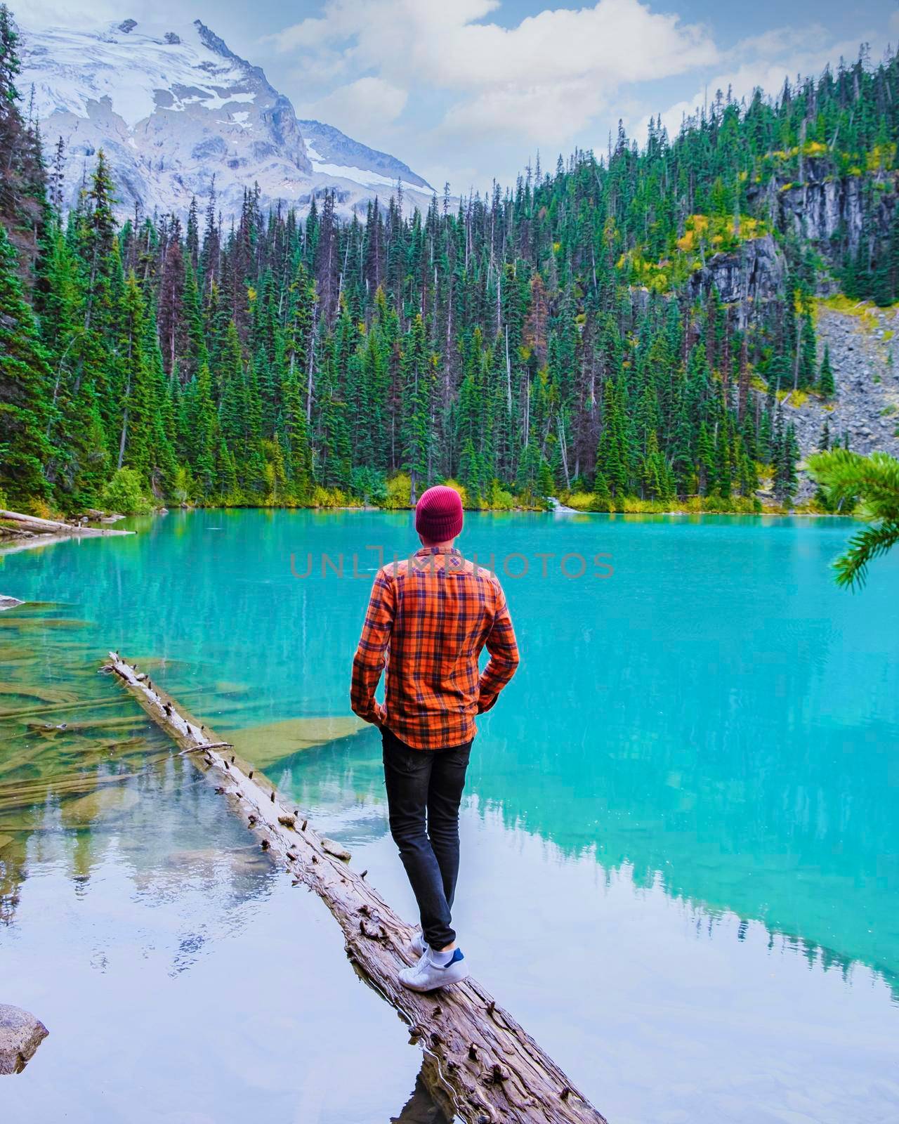Joffre Lakes British Colombia Whistler Canada, colorful lake of Joffre lakes national park in Canada. Young men with hat visiting Joffre lake