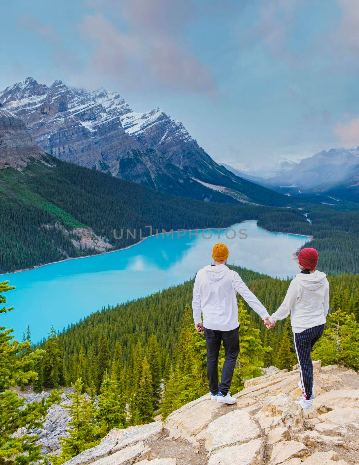 Lake Peyto in Banff National Park, Canada. Mountain Lake as a fox head is popular among tourists in Canada driving the icefields parkway. A couple of men and women looking out over the lake