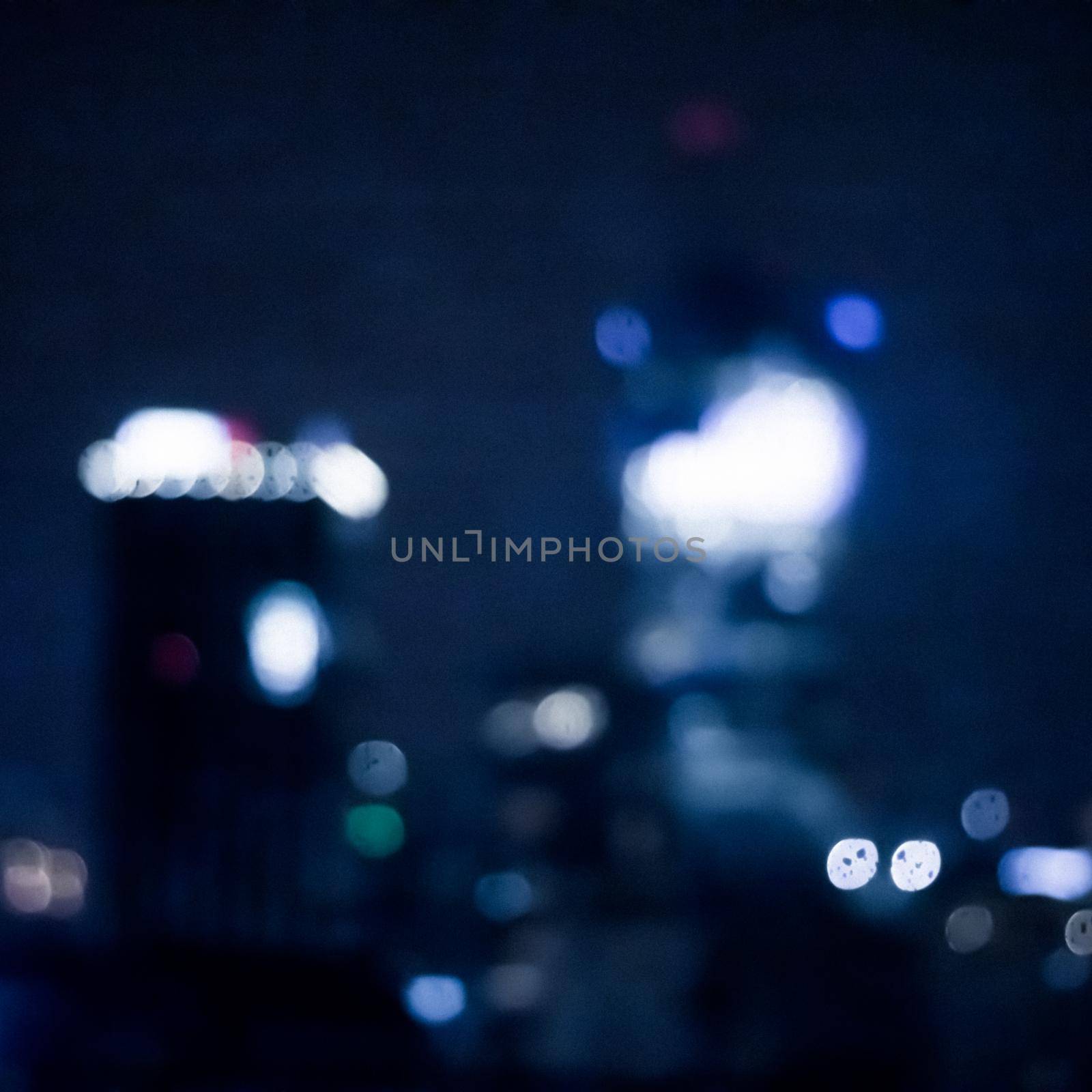 Blurry metropolitan district - night life, abstract background and modern dark tones concept. Big city comes alive at night