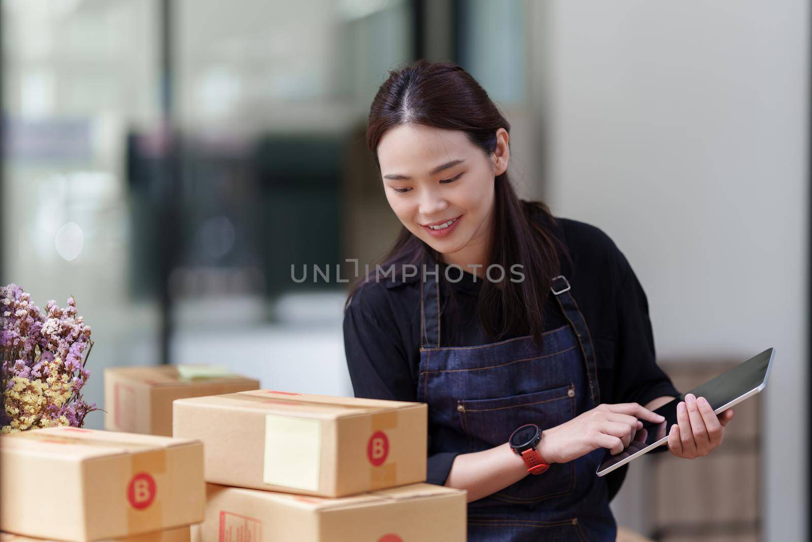 Portrait of modern Asian SME business woman entrepreneur at home office.